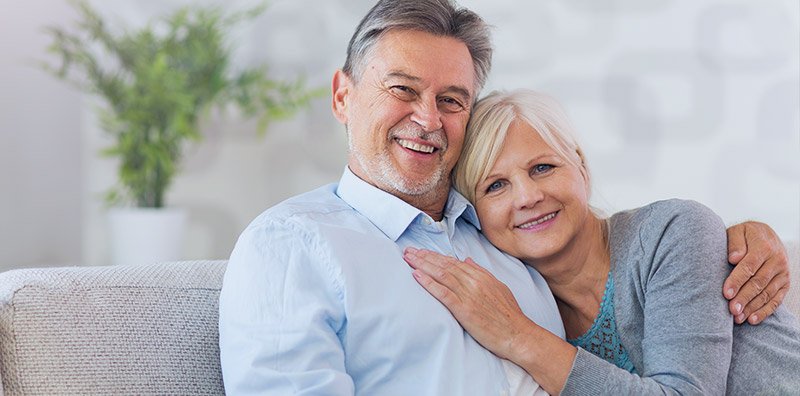 Senior couple sitting on couch