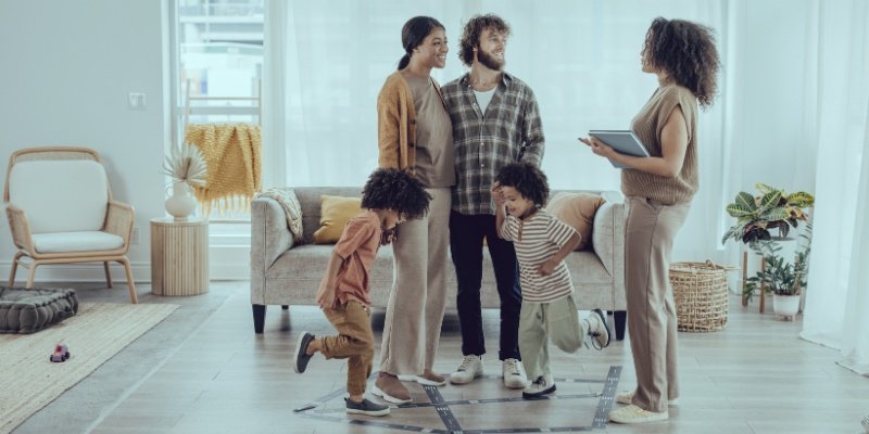 family speaking to real estate agent