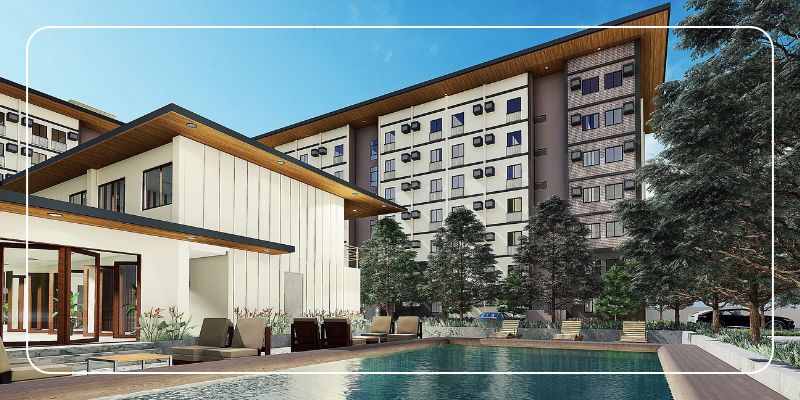 Modern condo community with a swimming pool, landscaped trees, and lounge seating, showcasing the lifestyle and amenities buyers look for when purchasing a condo.
