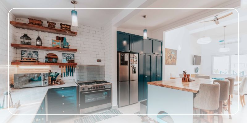A modern kitchen with blue cabinets, open wood shelves, a stainless steel stove and refrigerator. Ready for a home inspection.