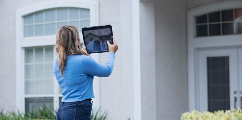 Property Appraiser taking picture of home